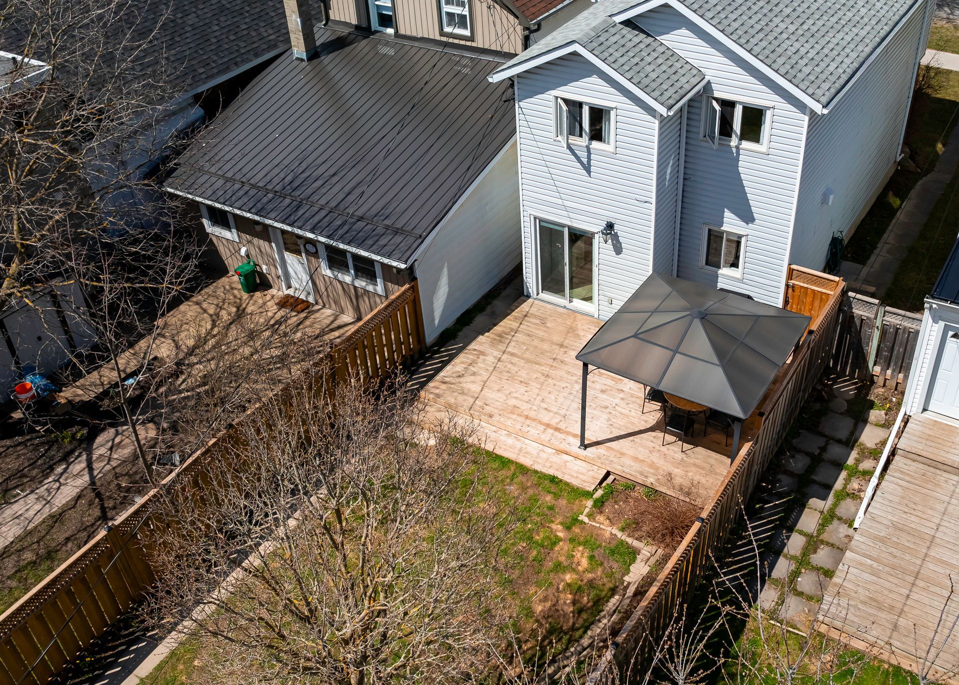 An aerial view of a house with a gazebo in the backyard.
