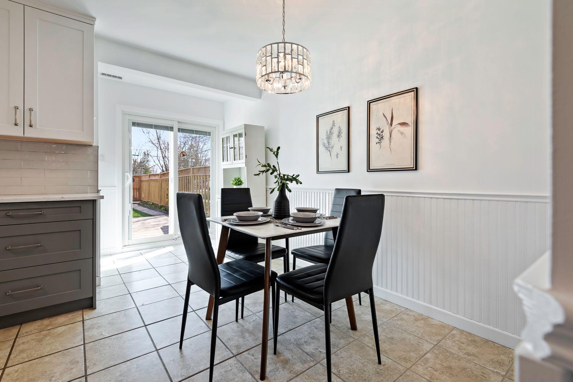 A dining room with a table and chairs and a chandelier.