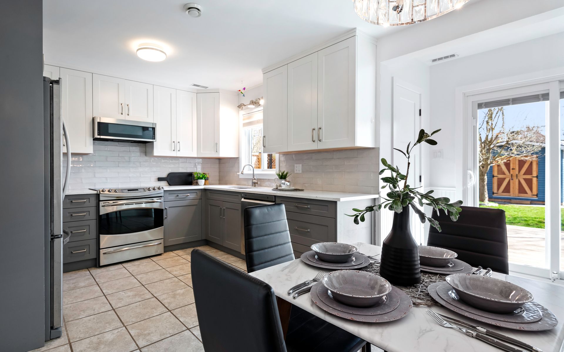 A kitchen with a dining table and chairs and a sliding glass door.
