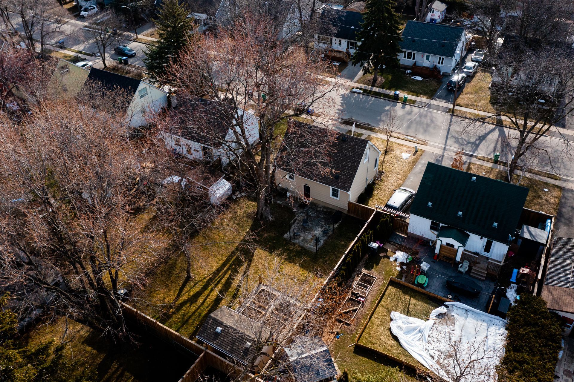 An aerial view of a residential area with houses and trees.
