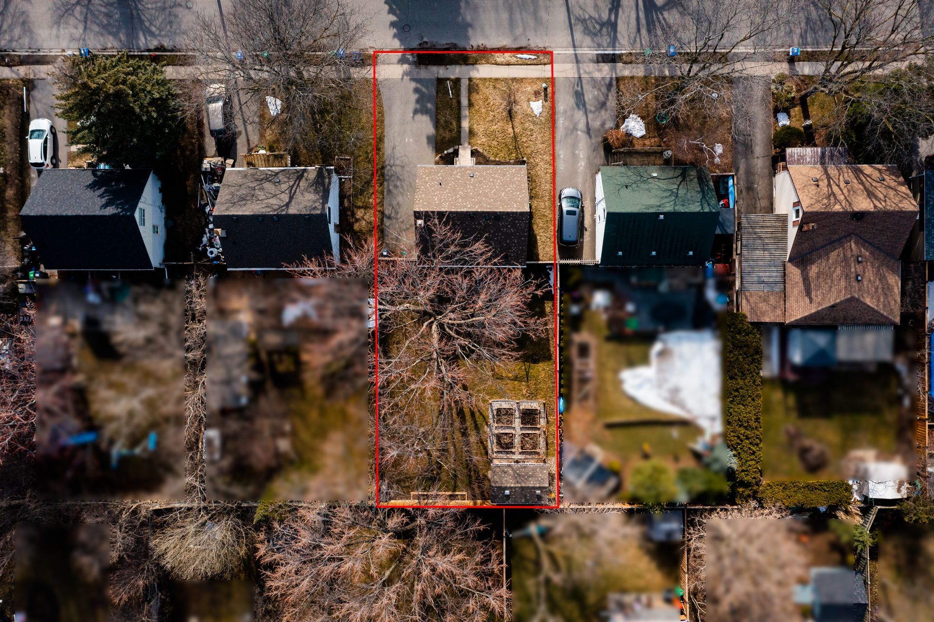 An aerial view of a residential area with a red line showing the location of a house.