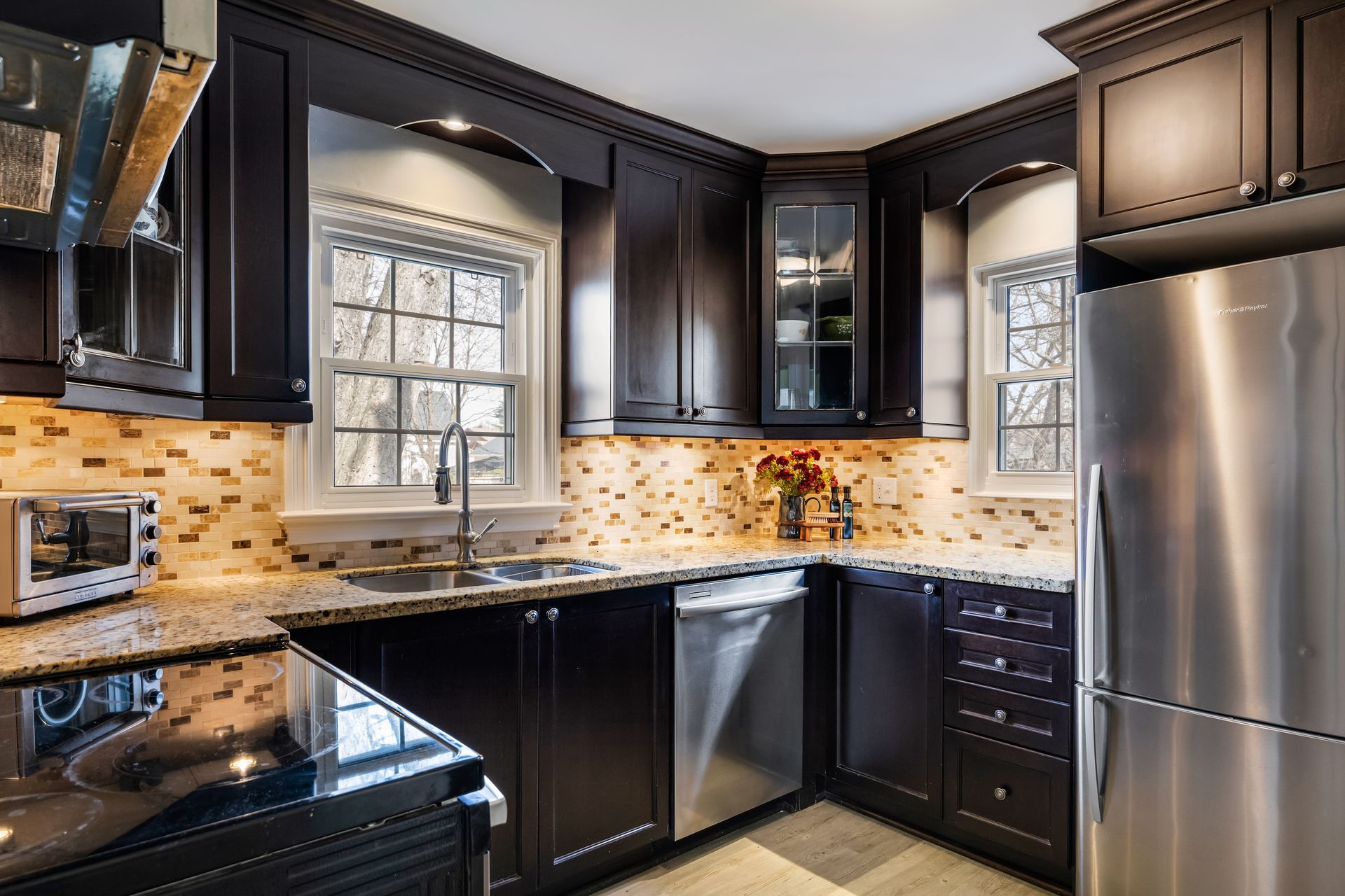 A kitchen with stainless steel appliances and black cabinets