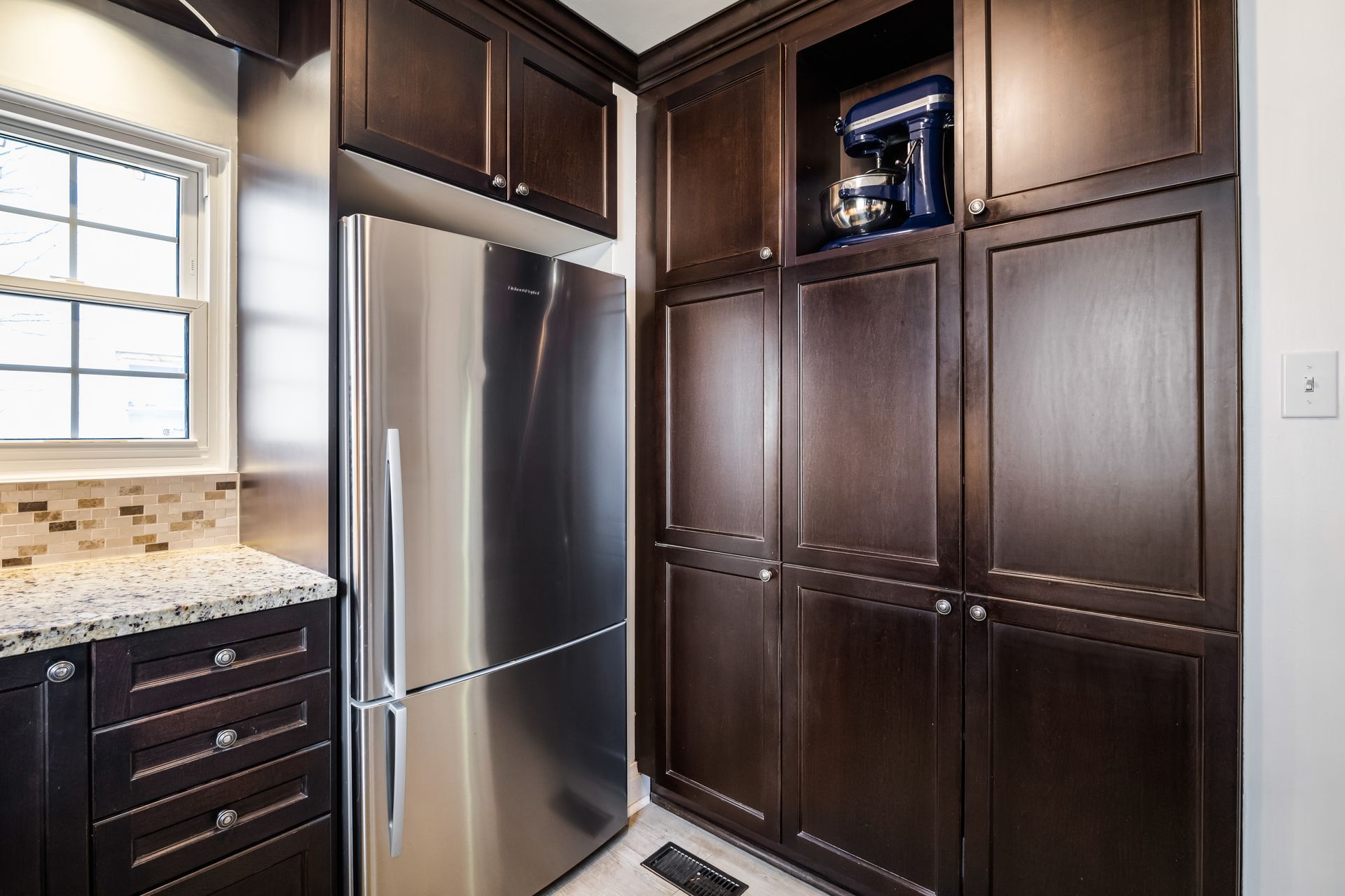 A kitchen with stainless steel appliances and wooden cabinets.