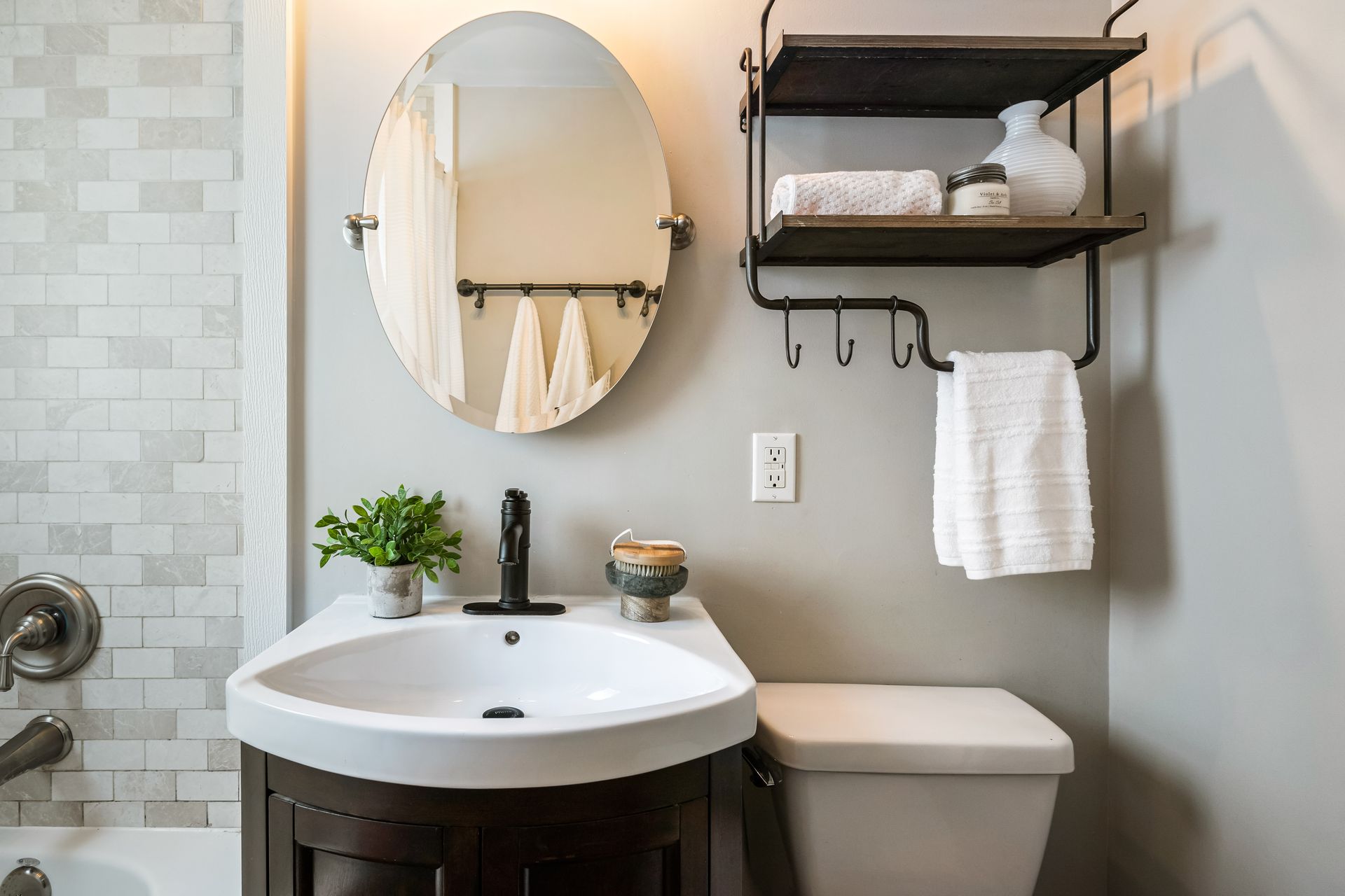 A bathroom with a sink , toilet , and mirror.