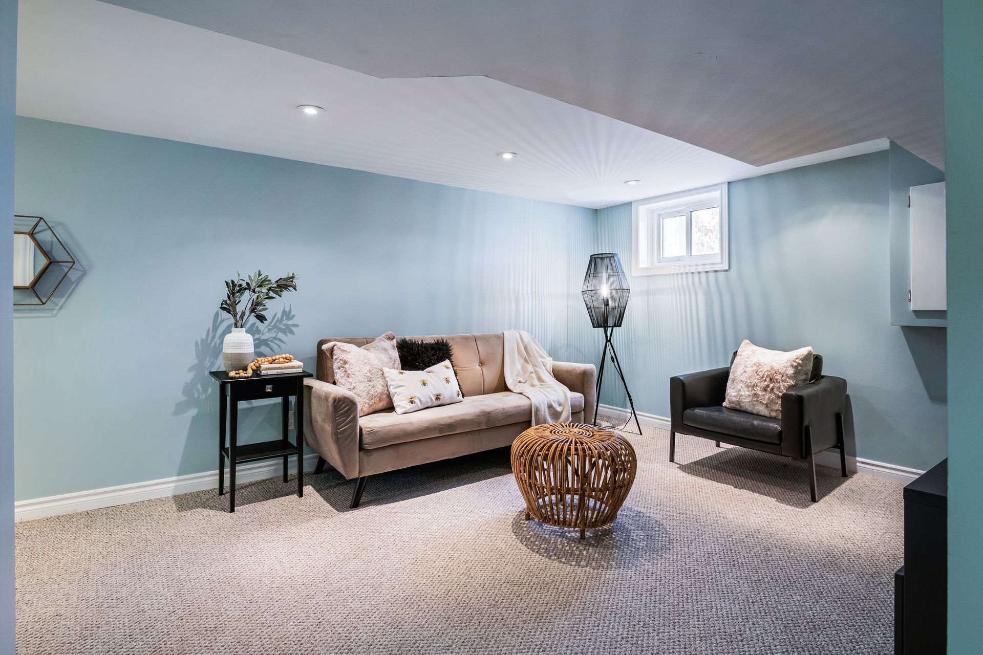 A living room with a couch , chairs , and a table.