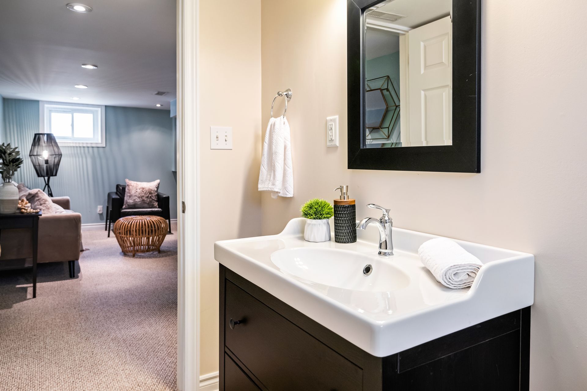 A bathroom with a sink and a mirror.