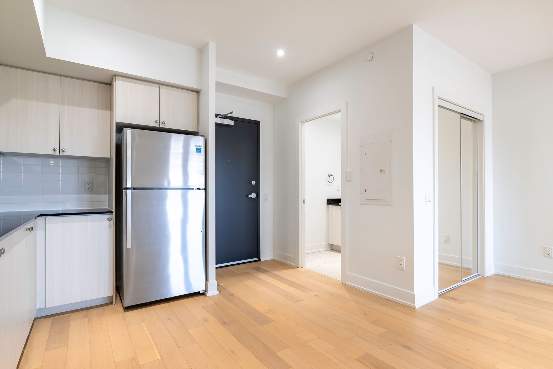There is a refrigerator in the middle of the room.