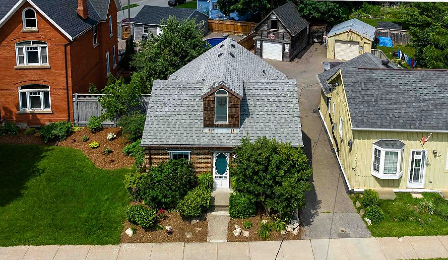 An aerial view of a house in a residential neighborhood