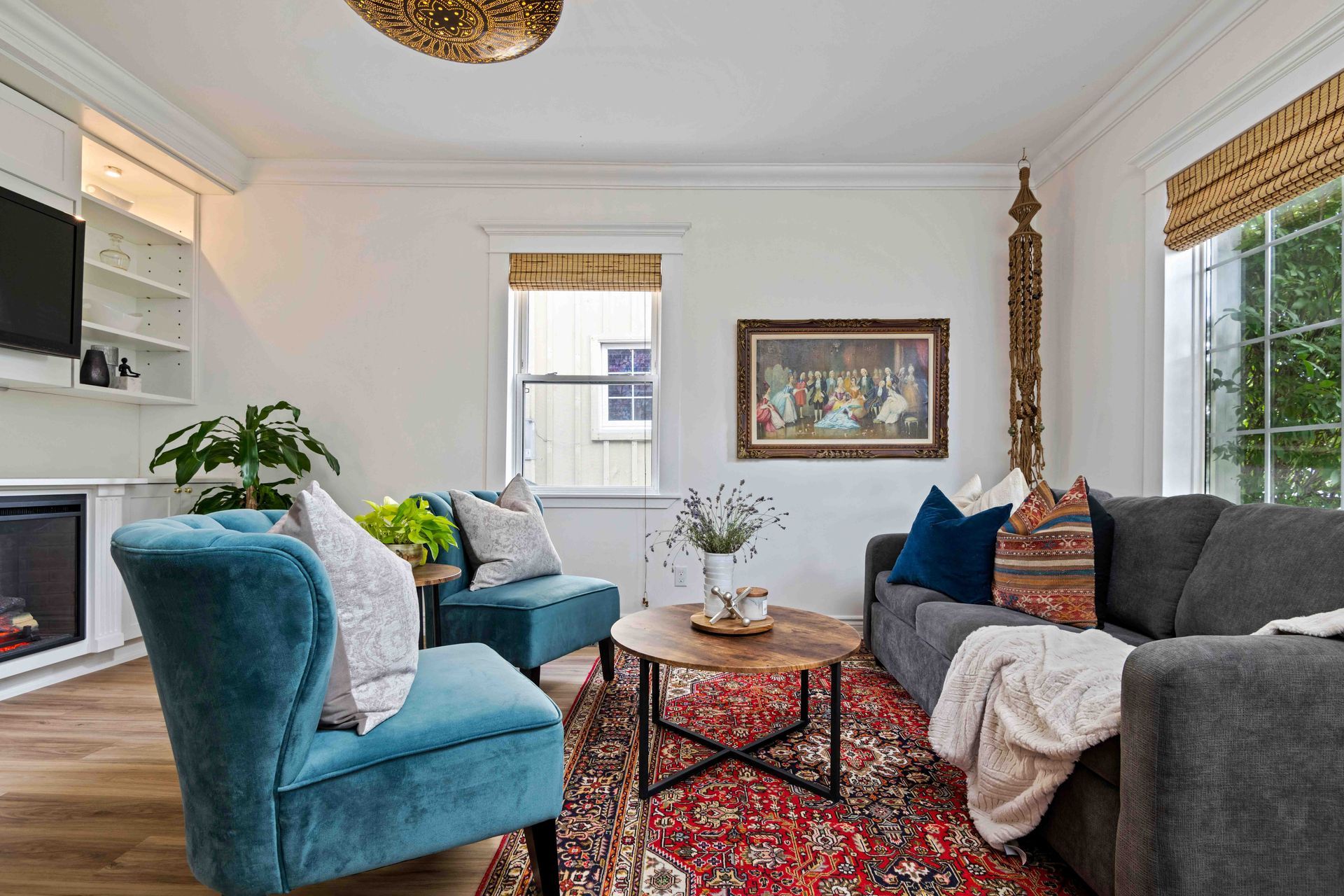 A living room with a couch , chairs , coffee table and fireplace.