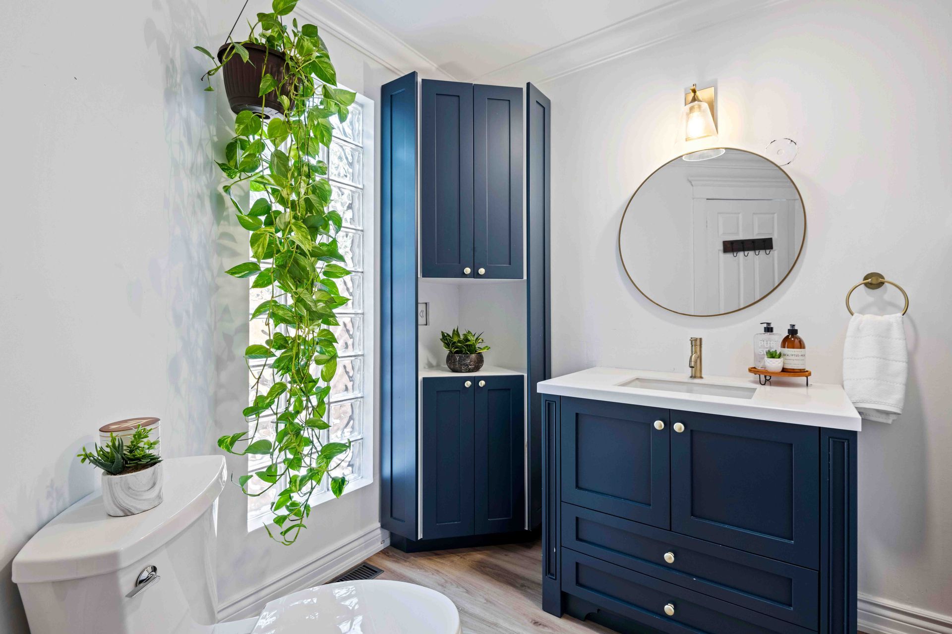 A bathroom with a toilet , sink , and mirror.