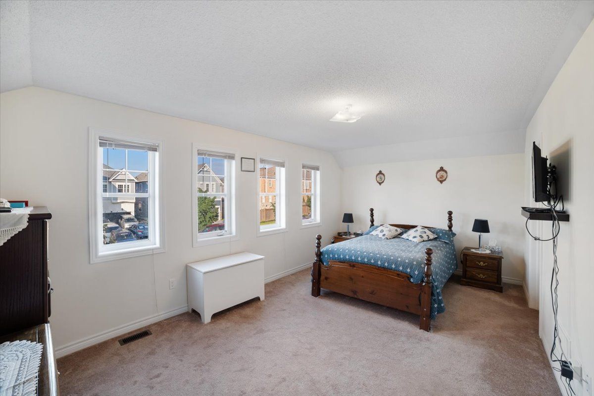A bedroom with a bed , nightstands , and a television.