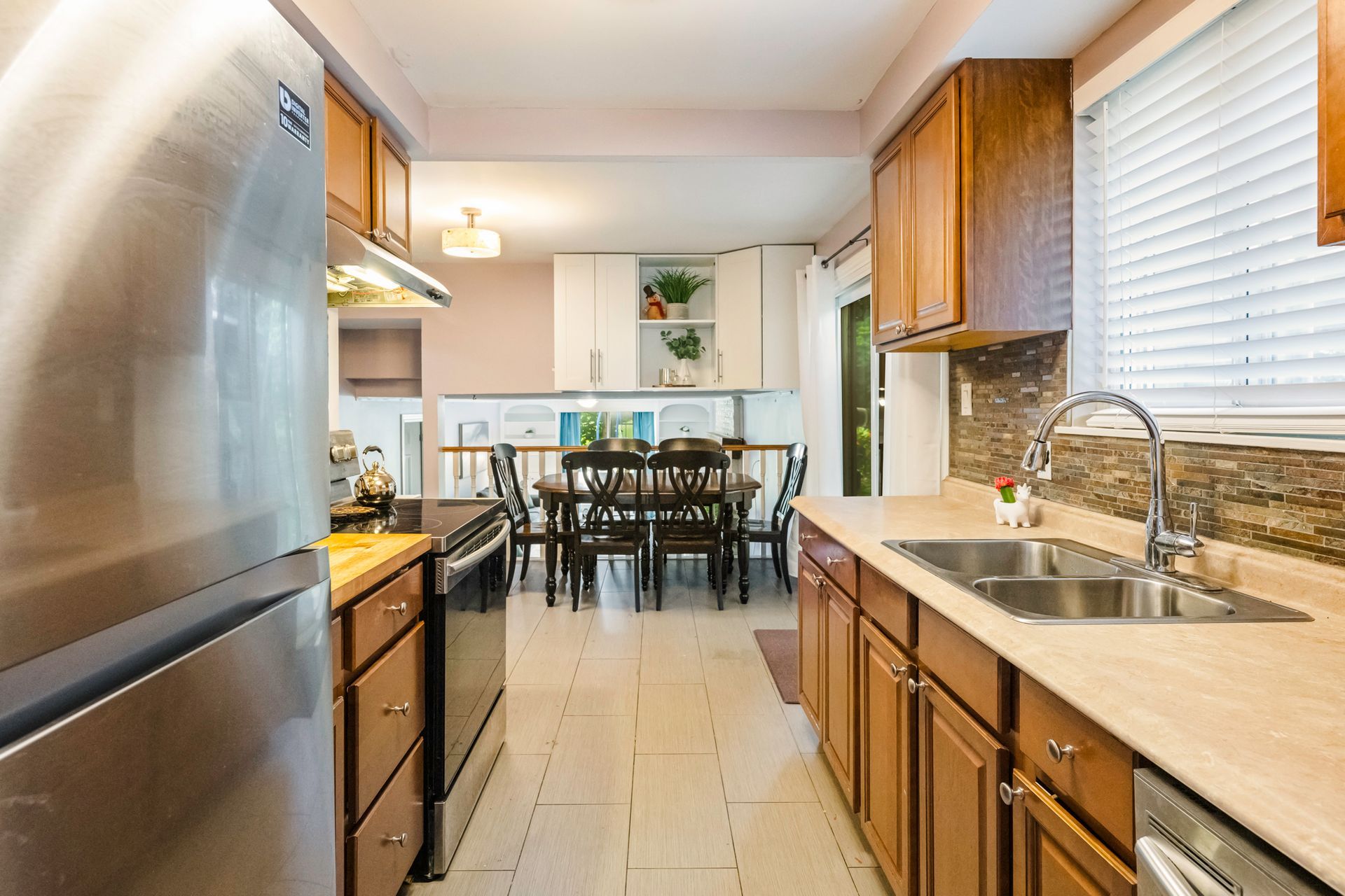 A kitchen with stainless steel appliances and wooden cabinets