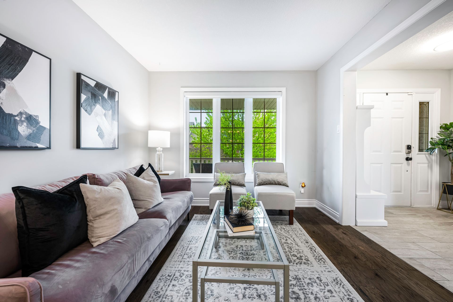 A living room with a couch , coffee table , and chairs.