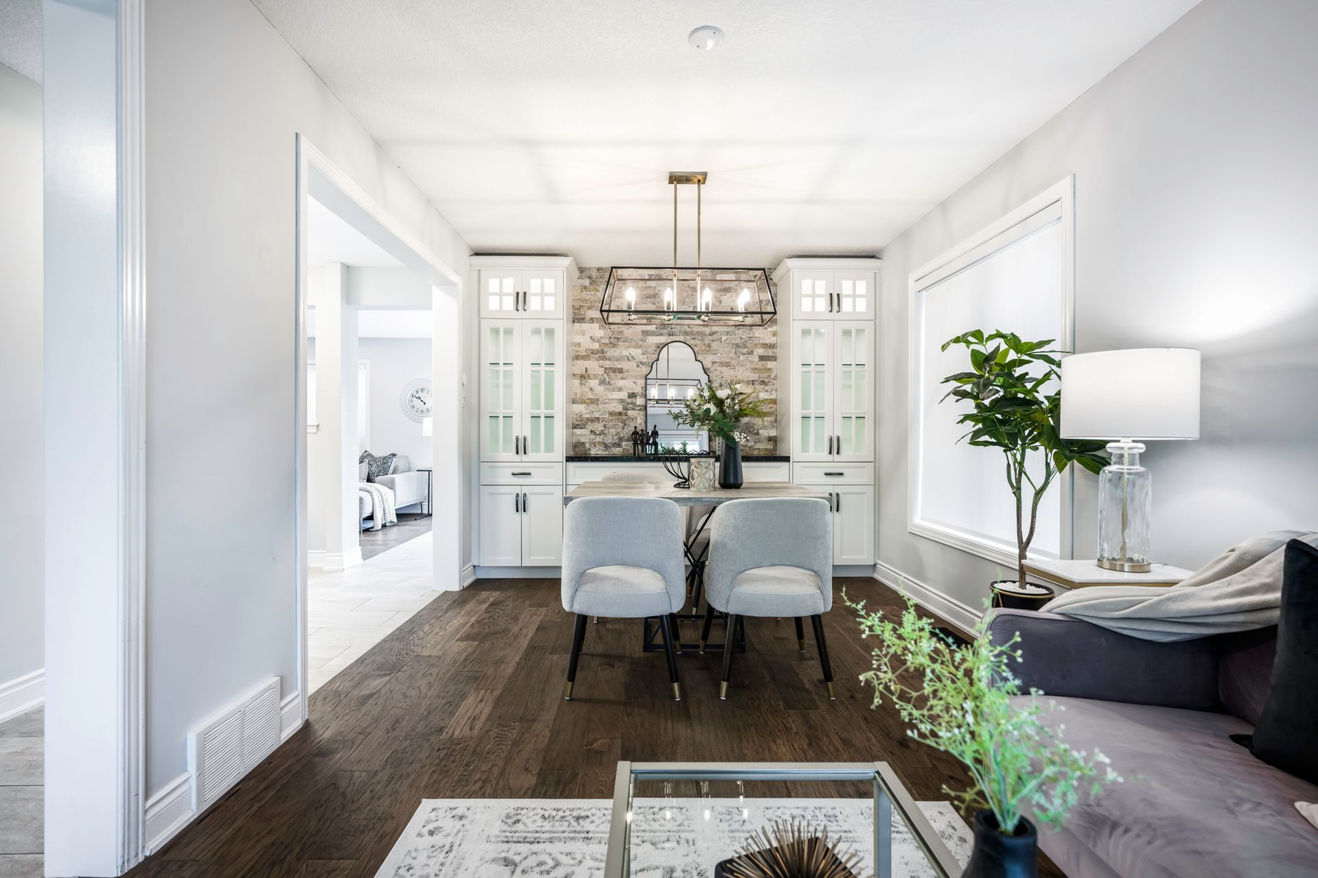 A living room with a dining room table and chairs and a couch.