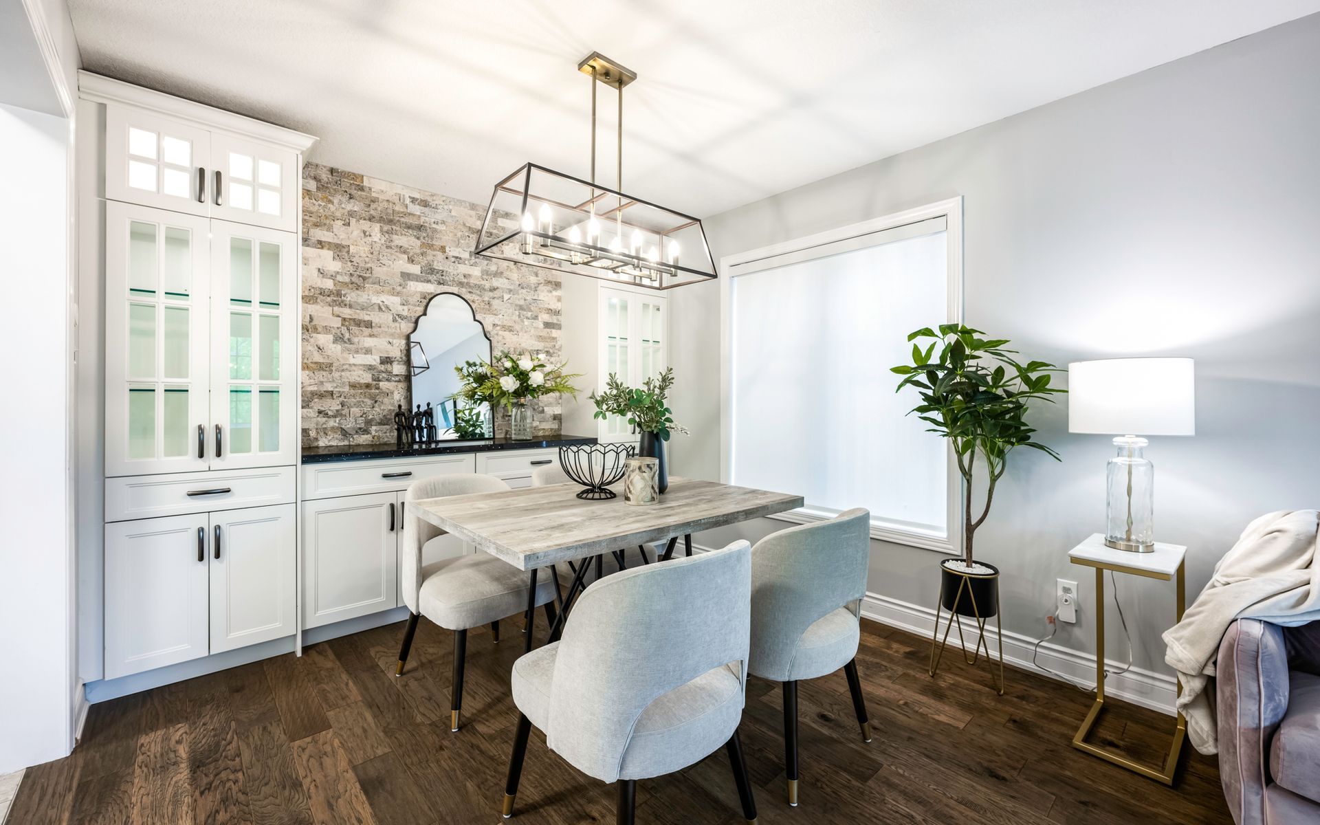 A dining room with a table and chairs and a chandelier.