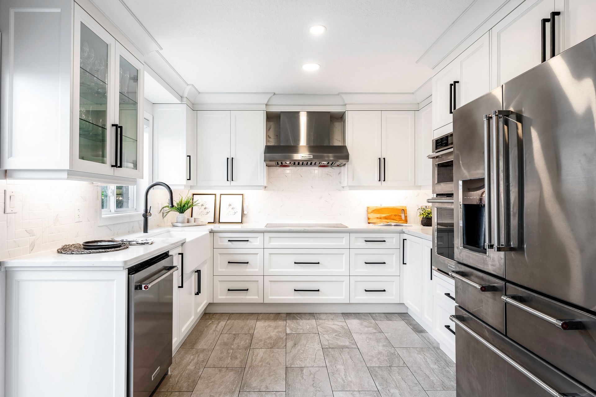 A kitchen with white cabinets and stainless steel appliances.