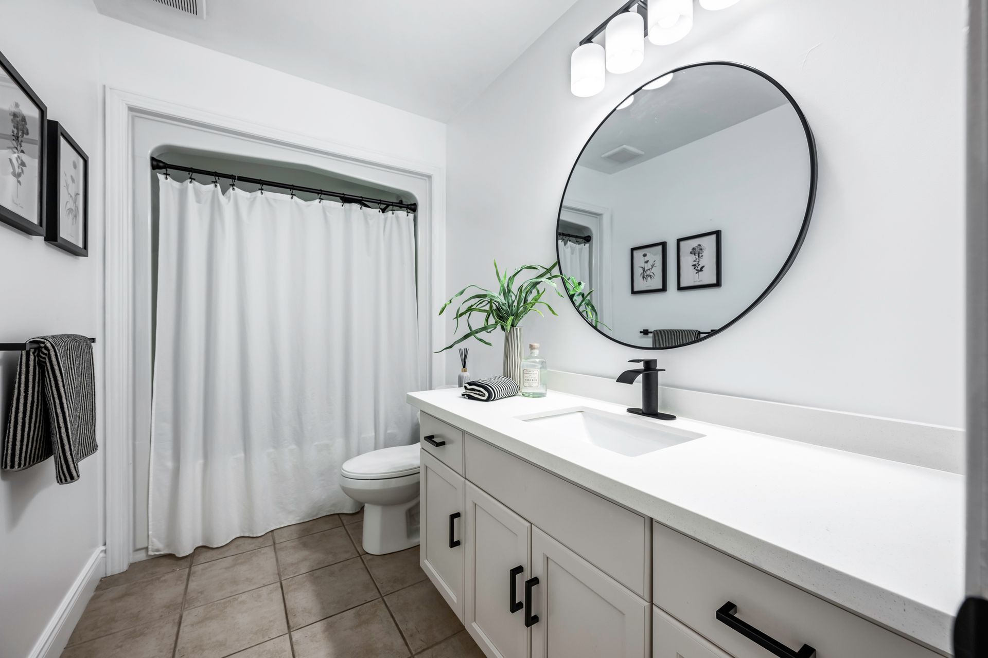 A bathroom with a sink , toilet , and mirror.