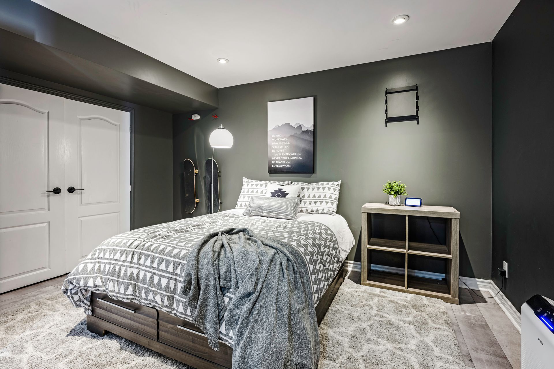 A bedroom with a bed , nightstand , and television.