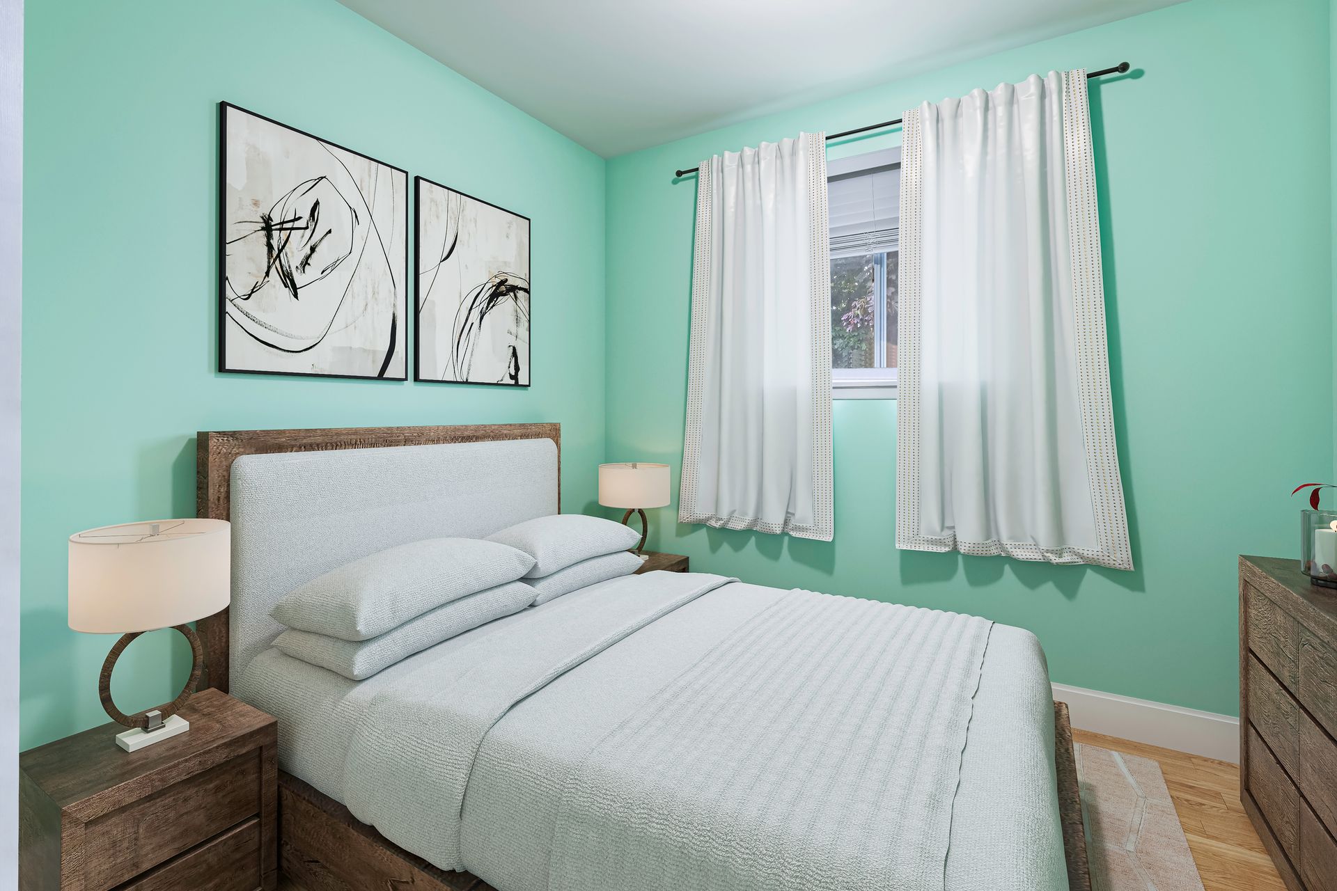 A bedroom with a bed , dresser , nightstand , lamps and green walls.