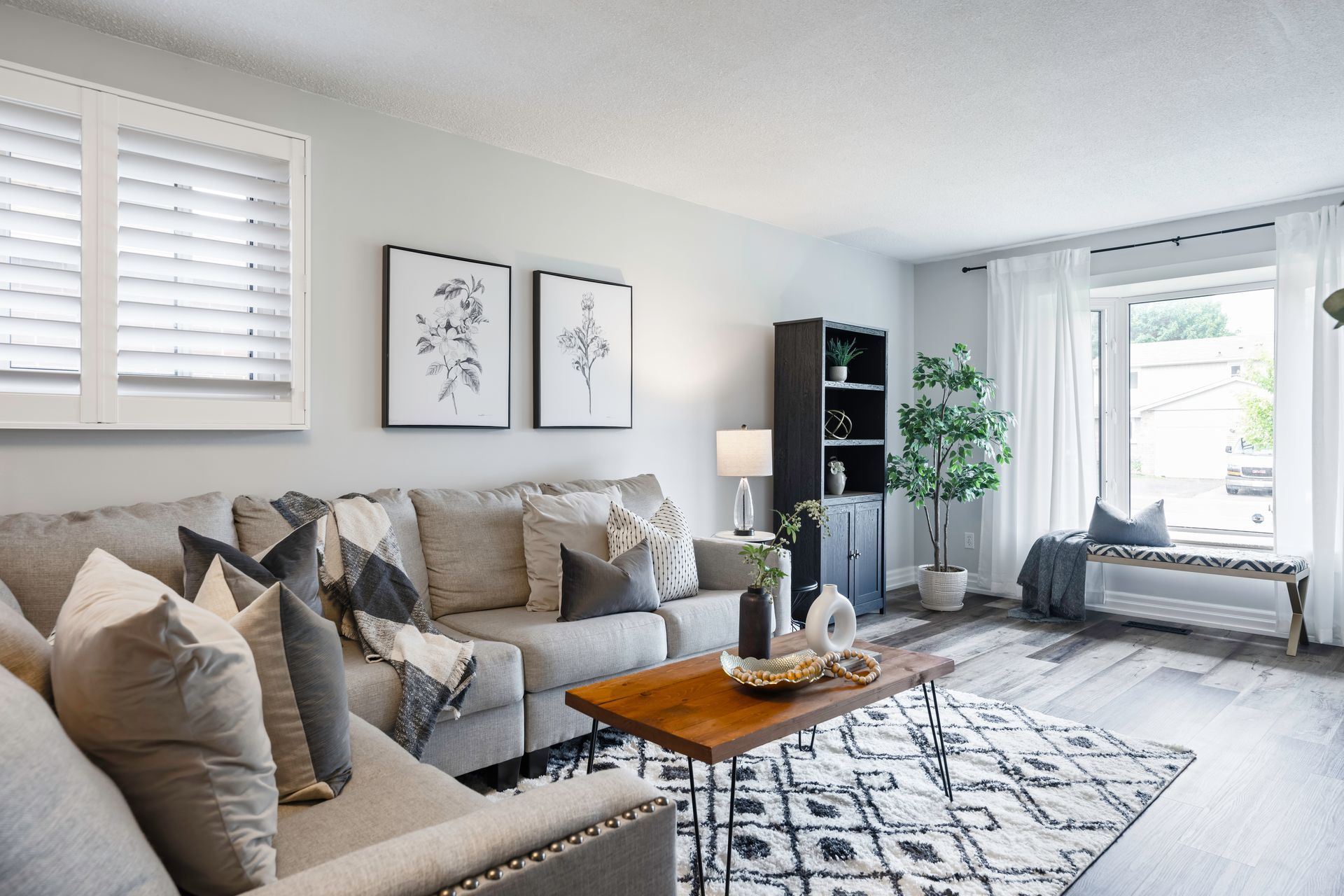 A living room with a couch , coffee table , and window.