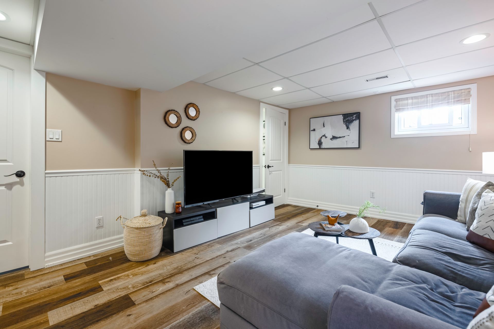 A living room with a couch and a flat screen tv.