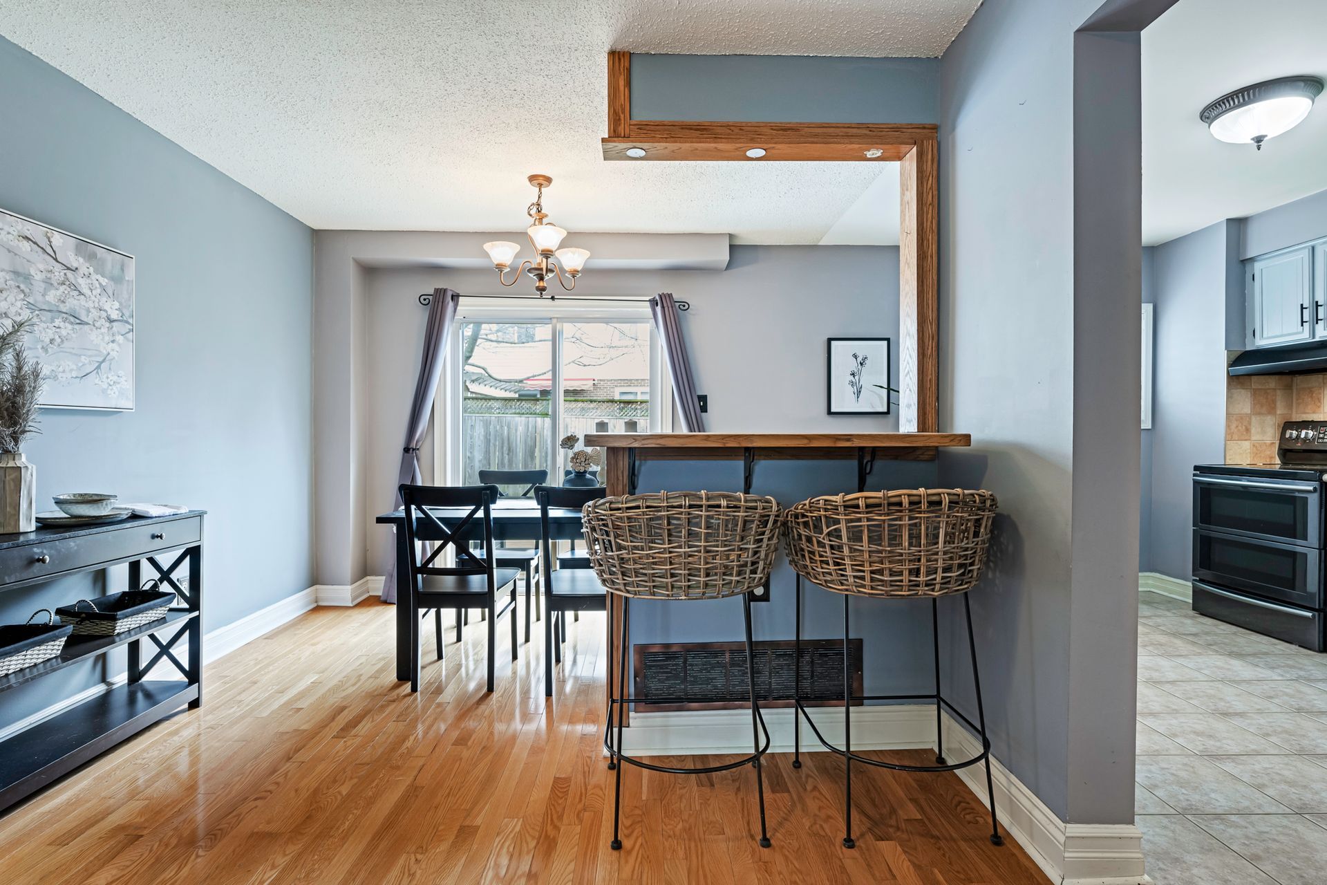 A dining room with a table and chairs and a bar