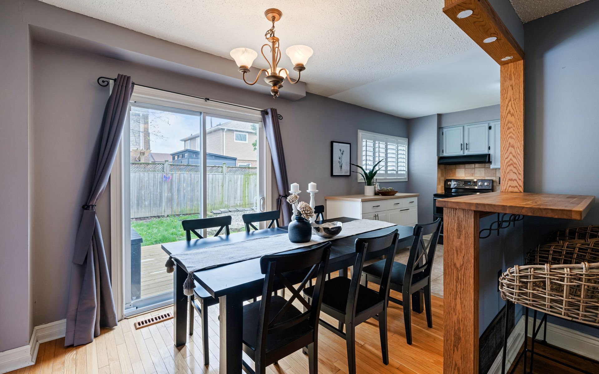 A dining room with a table and chairs and a chandelier.