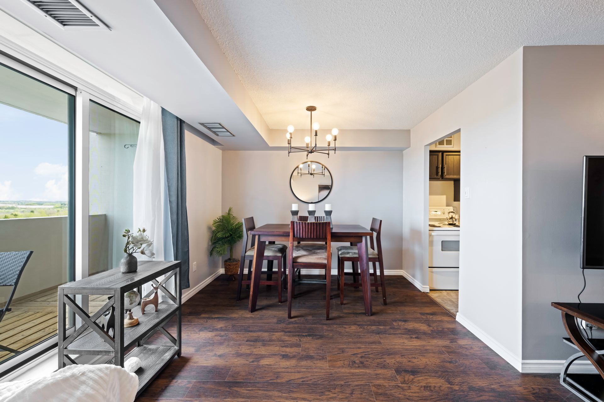 A living room with a dining room table and chairs
