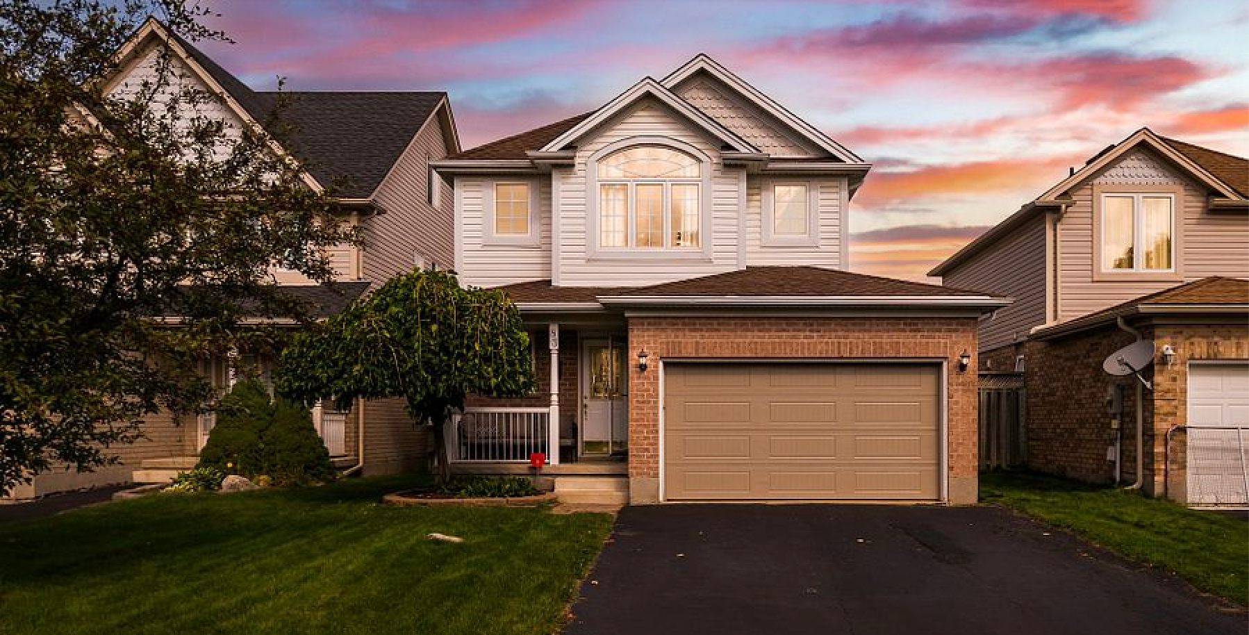 A house with a garage and a driveway is for sale.