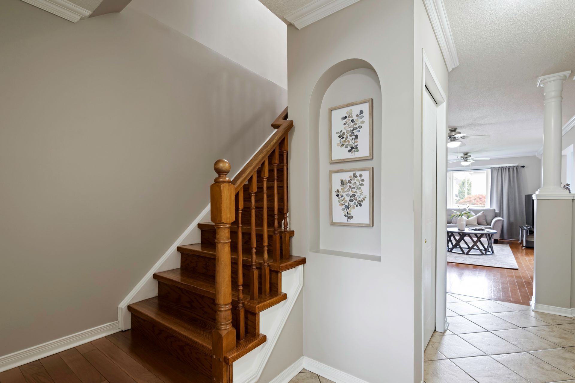 A hallway with stairs leading up to the second floor of a house.