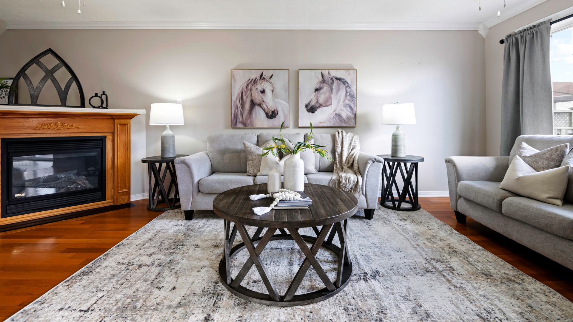 A living room with a couch , chair , coffee table and fireplace.