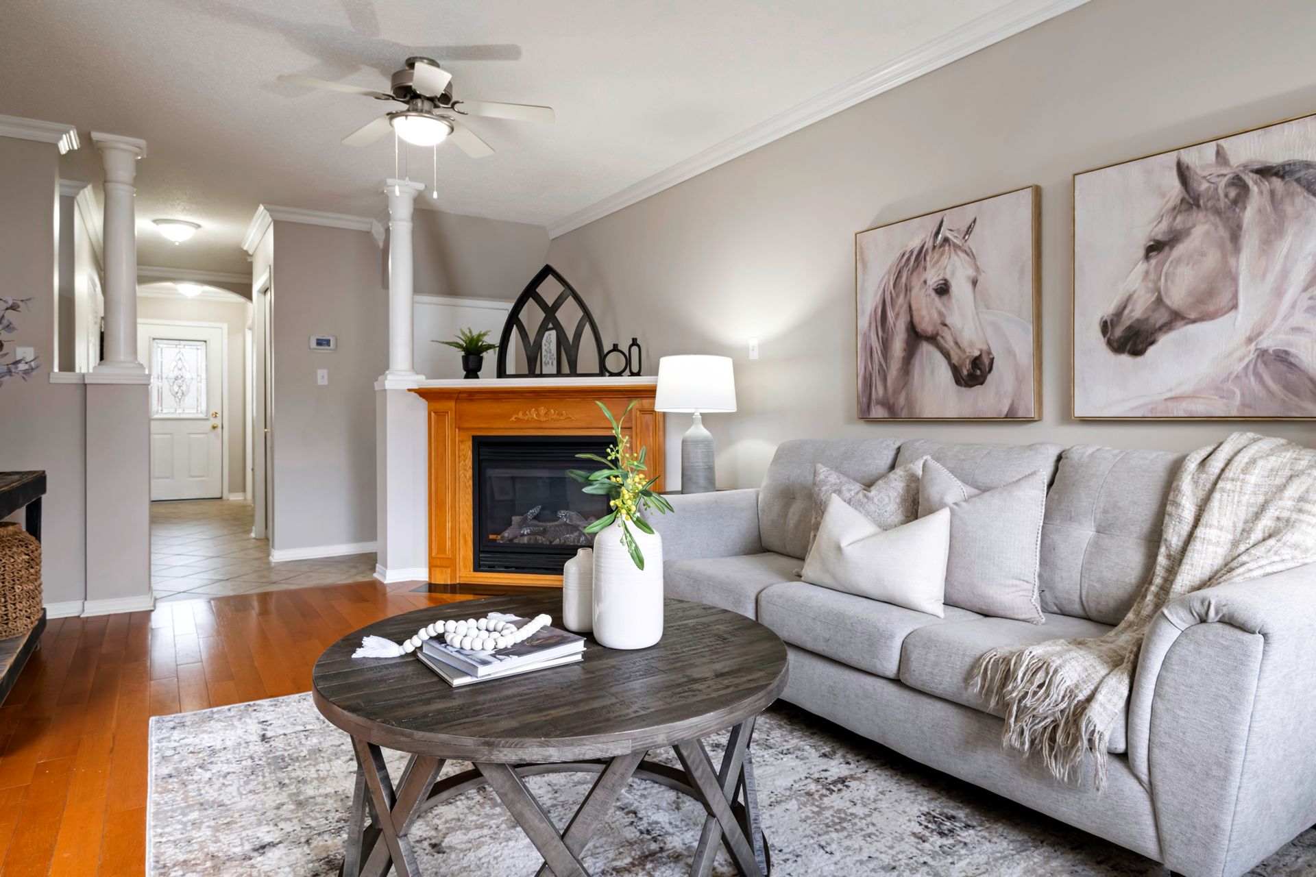A living room with a couch , coffee table and fireplace.