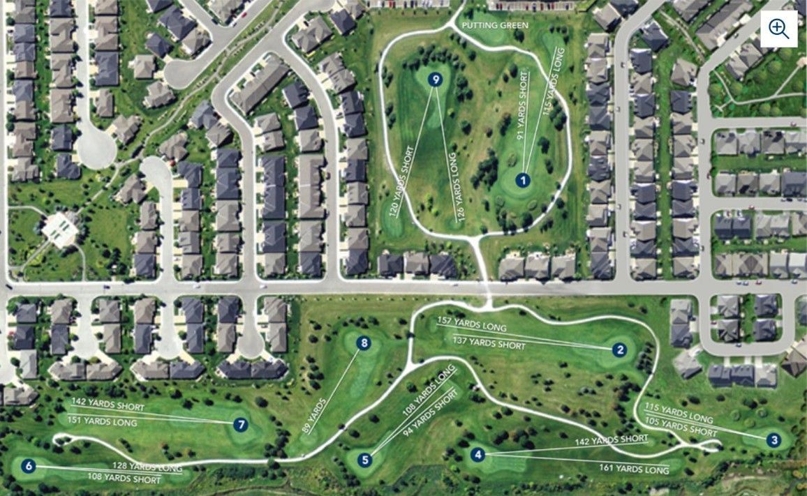 An aerial view of a residential area with a golf course