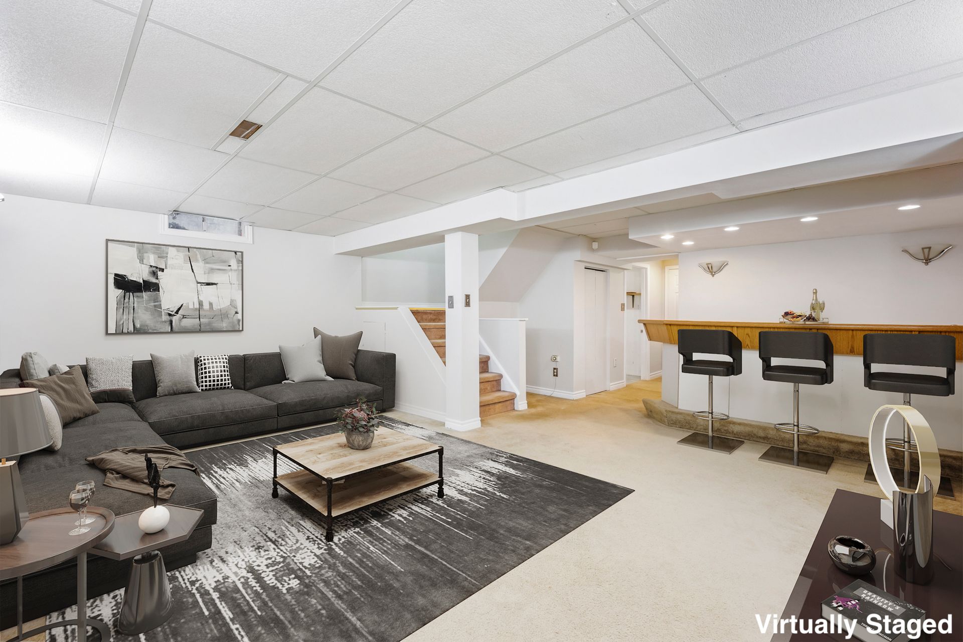 A living room with a couch , coffee table , chairs and a bar.