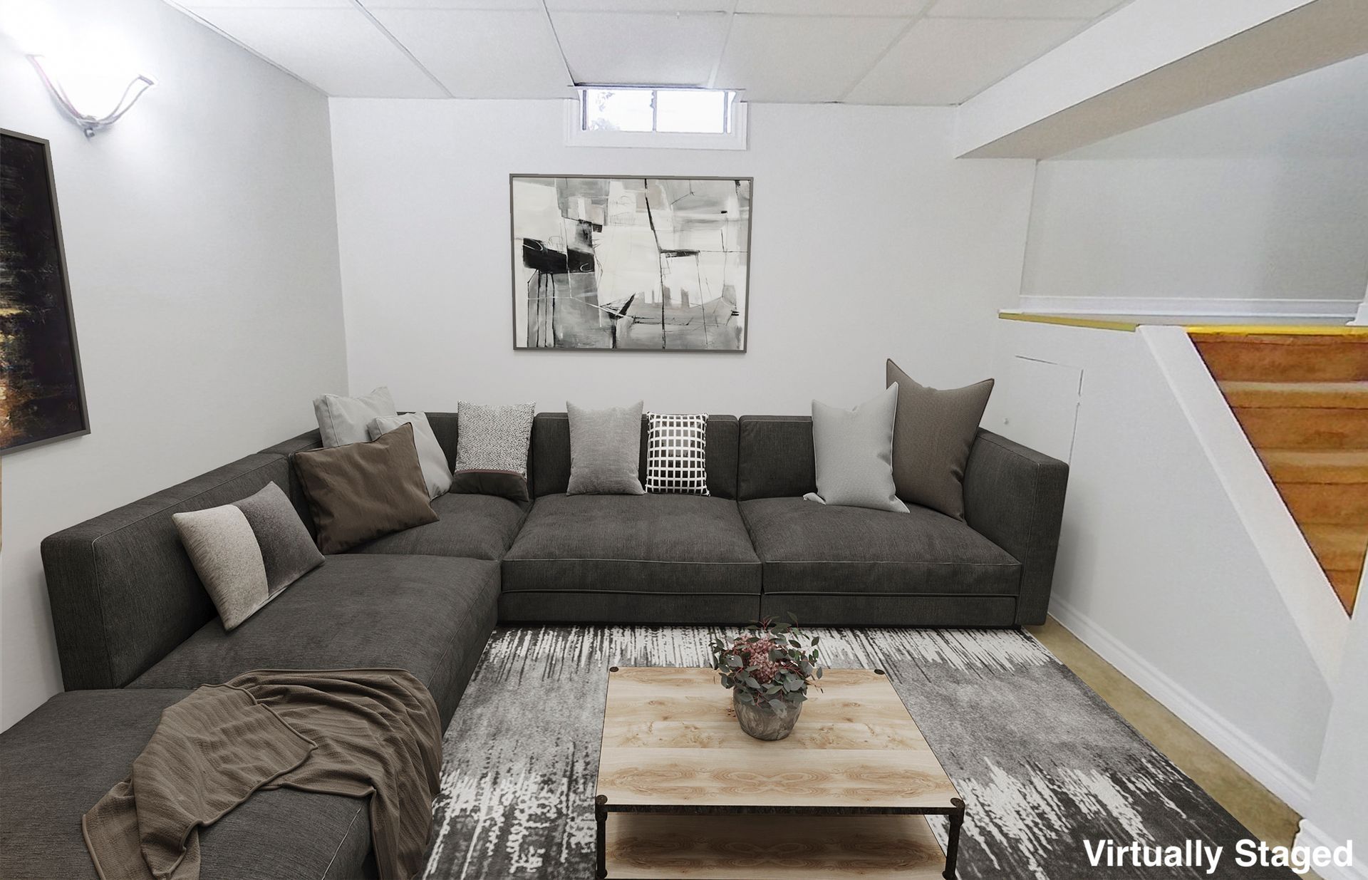 A living room with a large sectional couch and a coffee table