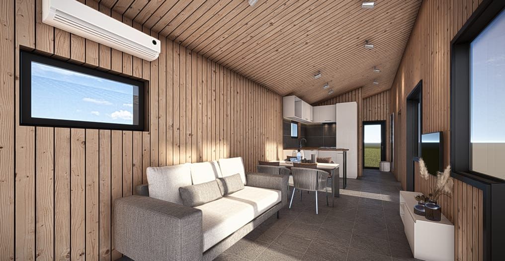 Interior of a modern tiny home with wood paneling, sofa, kitchen, and large windows.