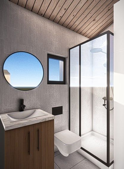 Modern bathroom with a wood cabinet, black-framed shower, round mirror, and a small window.