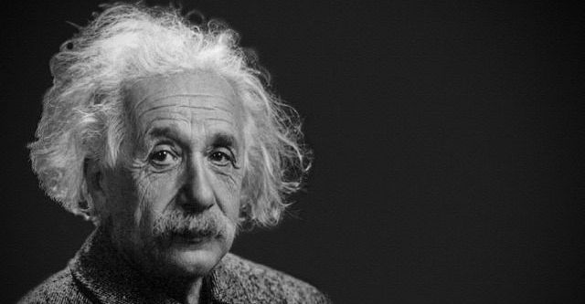 A black and white photo of Albert Einstein with a mustache