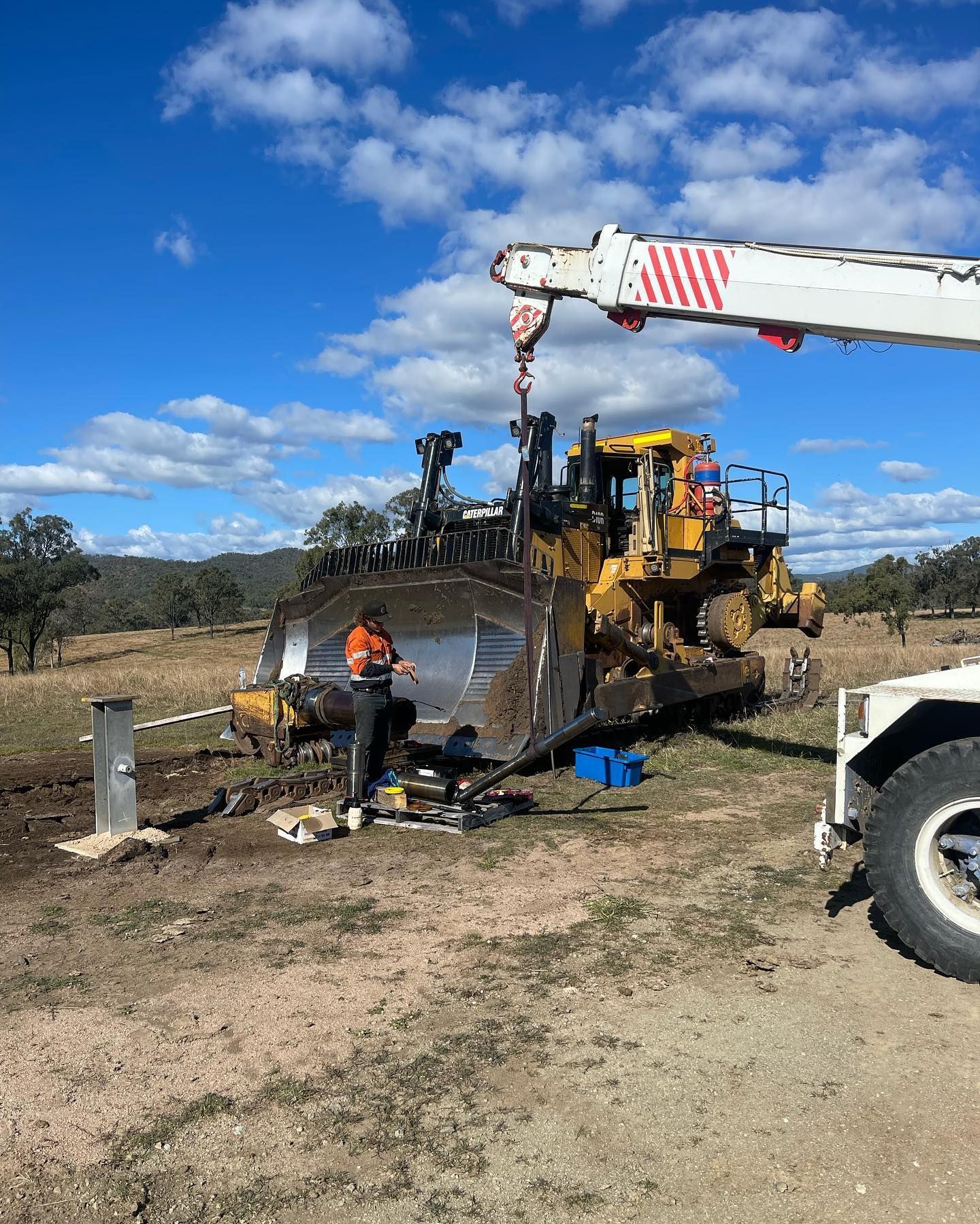 A Yellow Bulldozer is Lifted by a Crane Outdoors — HOLESHOT Diesel In Gympie, QLD