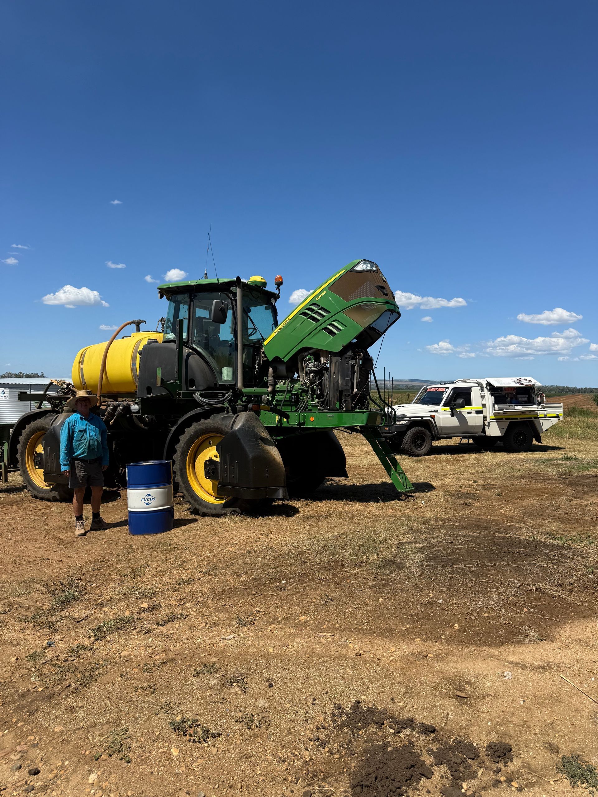 A Person Stands Next to a Large Green and Yellow Tractor   — HOLESHOT Diesel In Gympie, QLD