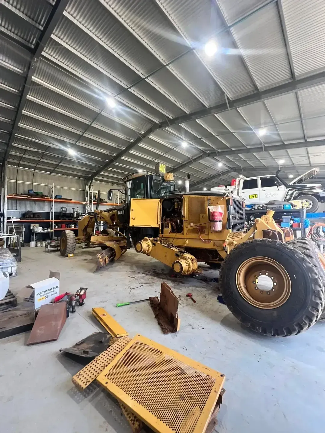 Yellow Road Grader Inside a Workshop — HOLESHOT Diesel In Sunshine Coast, QLD