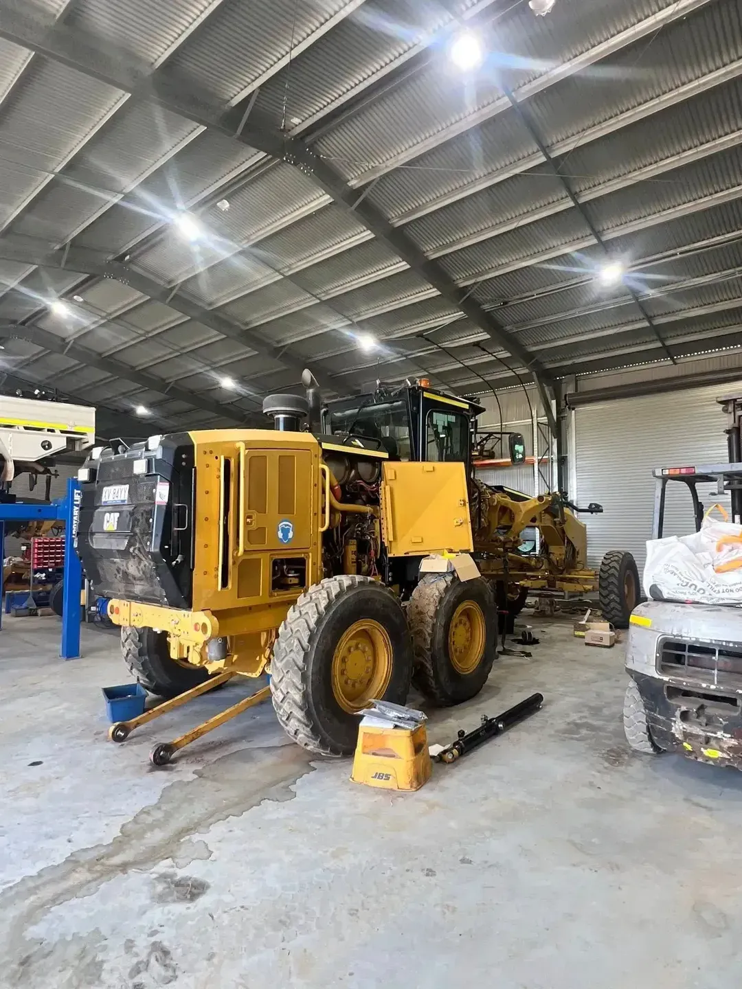Yellow Grader Machine Inside a Workshop — HOLESHOT Diesel In Brisbane, QLD