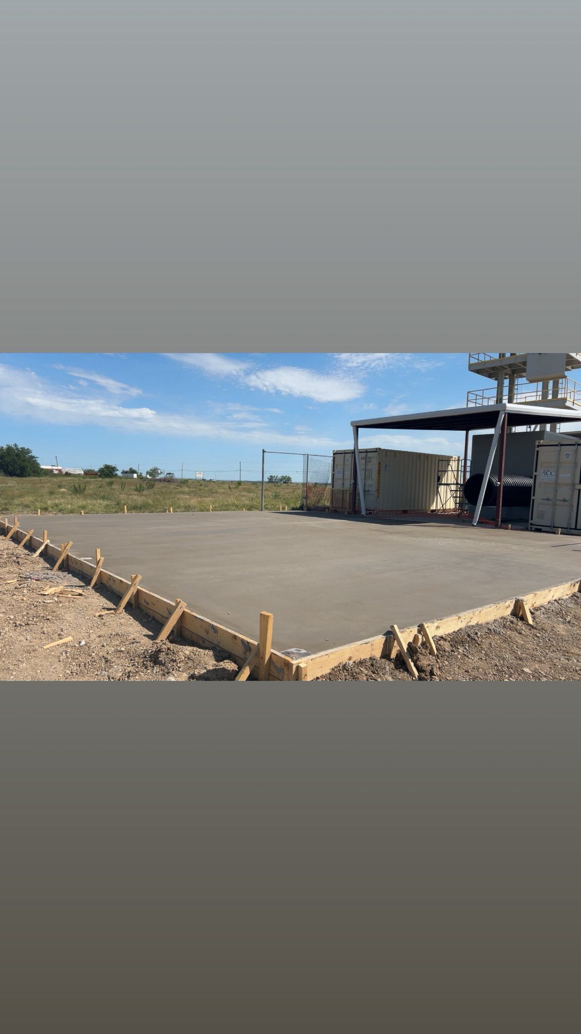 Concrete slab in wooden frame, outdoors. Building material and structure in progress on a construction site.