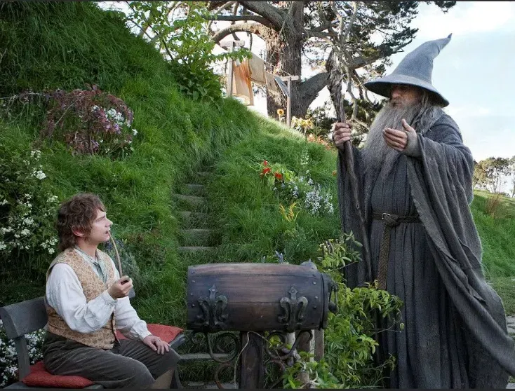 A man sitting on a bench next to a wizard