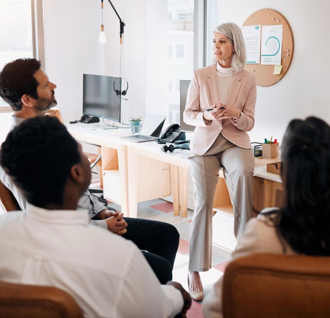 An engaged professional woman actively participating in a meeting, sharing insights in discussions.