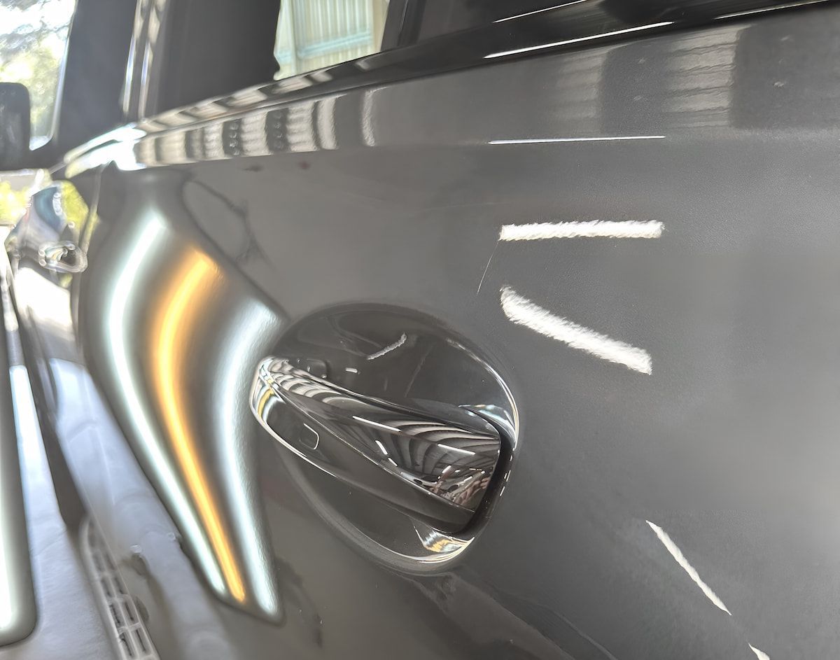 A Close Up of a Car With a Damaged Door Handle — Rapid Auto Dent In Lake Haven, NSW