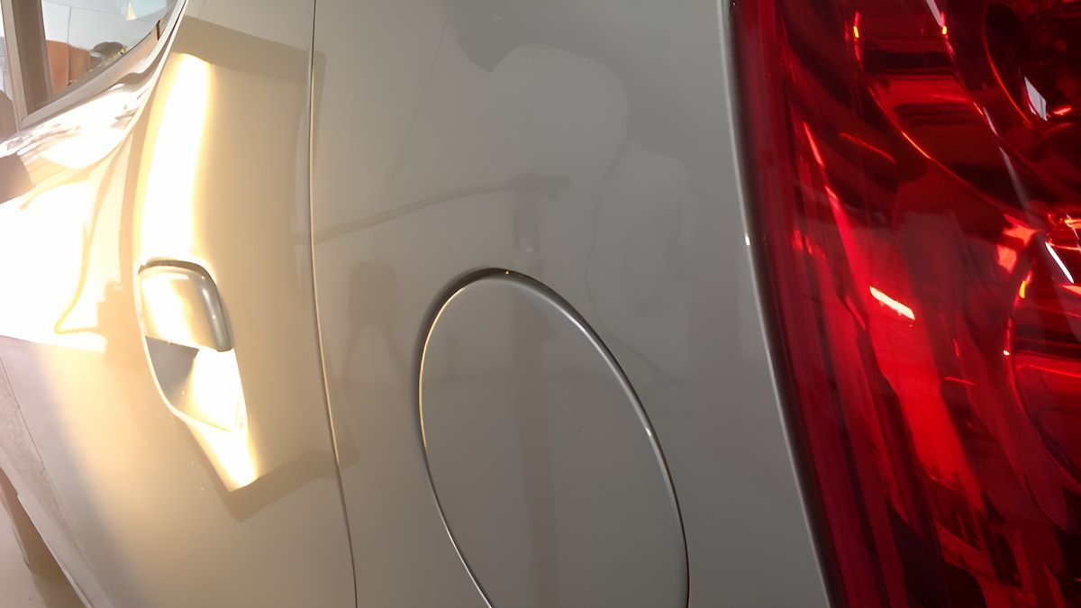 A Close Up Of A White Car With A Red Tail Light — Rapid Auto Dent In Erina, NSW