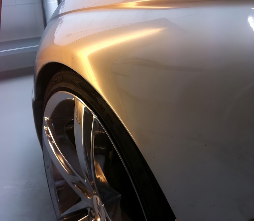 A Close Up Of A Silver Car's Fender And Wheel — Rapid Auto Dent In Erina, NSW