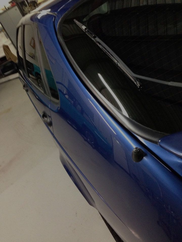 A Blue Car With a Windshield Wiper is Parked in a Garage — Rapid Auto Dent In The Entrance, NSW