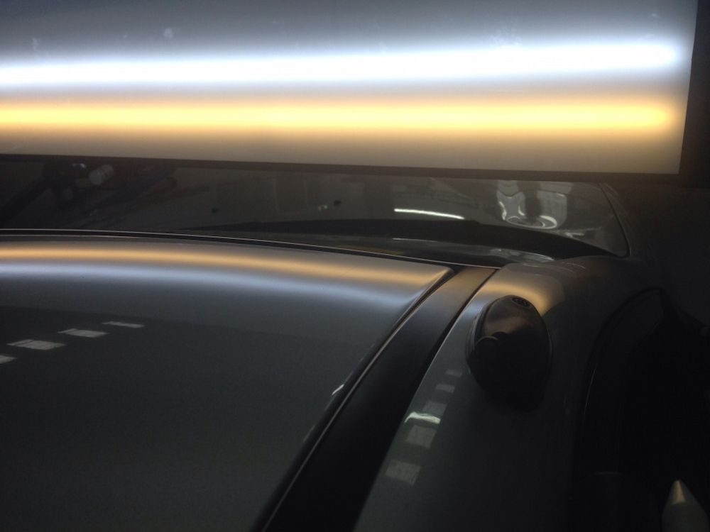 A Close Up Of A Car's Roof With A Light Shining On It — Rapid Auto Dent In Umina, NSW